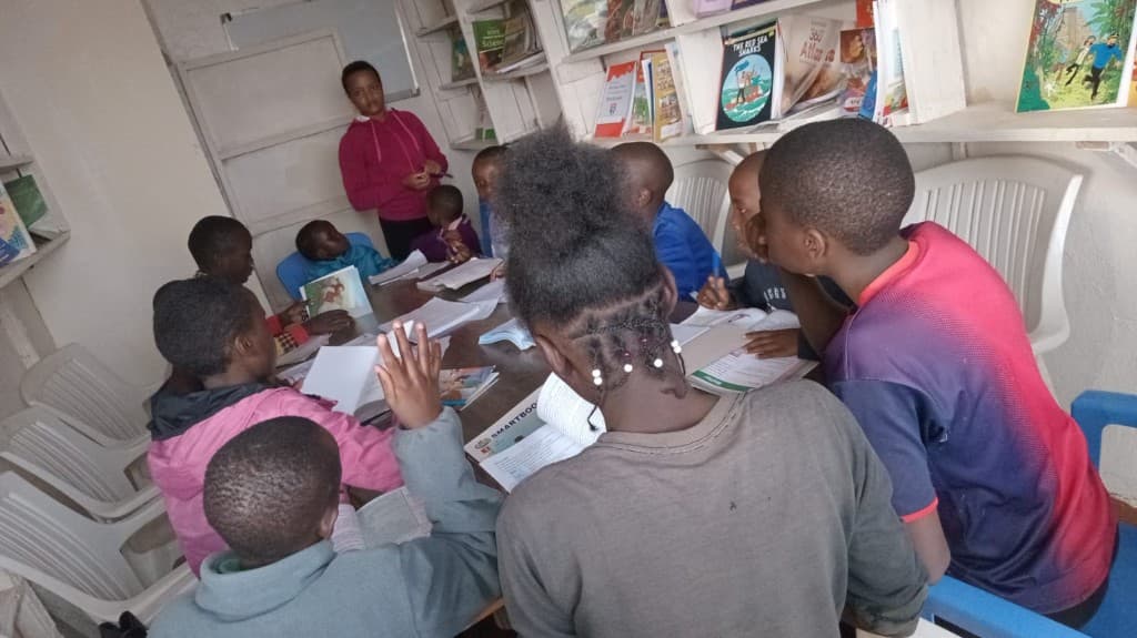 A facilitator leading a community group session in the library.